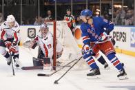 Washington Capitals goaltender Charlie Lindgren (79) and Martin Fehervary (42) protect the net from New York Rangers' Artemi Panarin (10) during the second period in Game 2 of an NHL hockey Stanley Cup first-round playoff series, Tuesday, April 23, 2024, in New York. (AP Photo/Frank Franklin II)