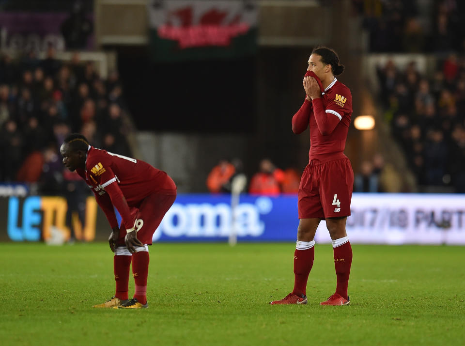 Liverpool players Sadio Mane (left) and Virgil van Dijk rue a loss at Swansea. (Getty)