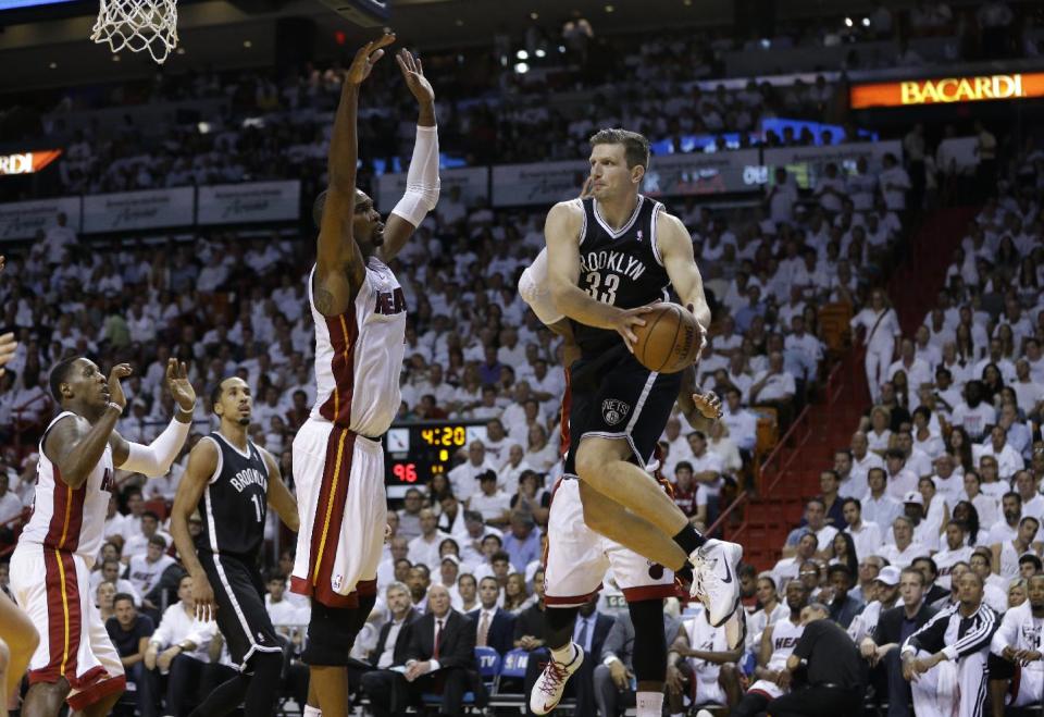 Brooklyn Nets' Mirza Teletovic (33) passes as Miami Heat's Chris Bosh defends in the second half of Game 1 in an Eastern Conference semifinal basketball game, Tuesday, May 6, 2014, in Miami. The Heat defeated the Nets 107-86. (AP Photo/Lynne Sladky)