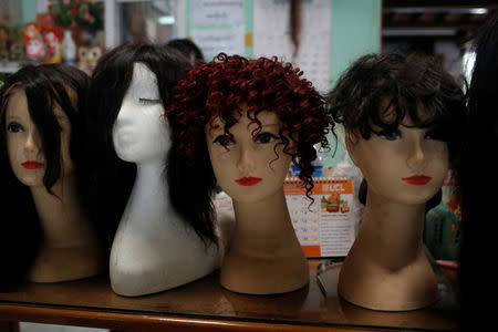Real hair wigs are displayed at Tet Nay Lin Trading Co. in Yangon, Myanmar, June 19, 2018. Picture taken June 19, 2018. REUTERS/Ann Wang