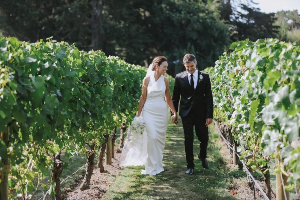 Ms Ardern wore a fitted ivory dress and a long veil by designer Juliette Hogan (EPA)