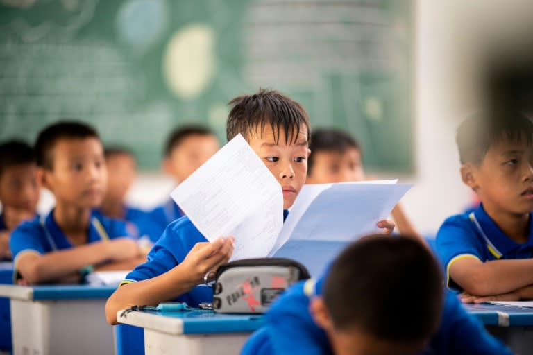 Boys listen and study during a 'football English' class at the academy