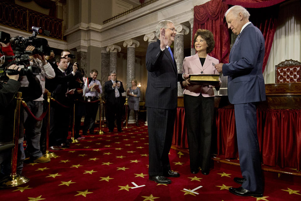 Vice President Biden administers the Senate oath to incoming Senate Majority Leader Mitch McConnell, with McConnell's wife Elaine Chao, during a ceremonial re-enactment swearing-in ceremony, Jan. 6, 2015.