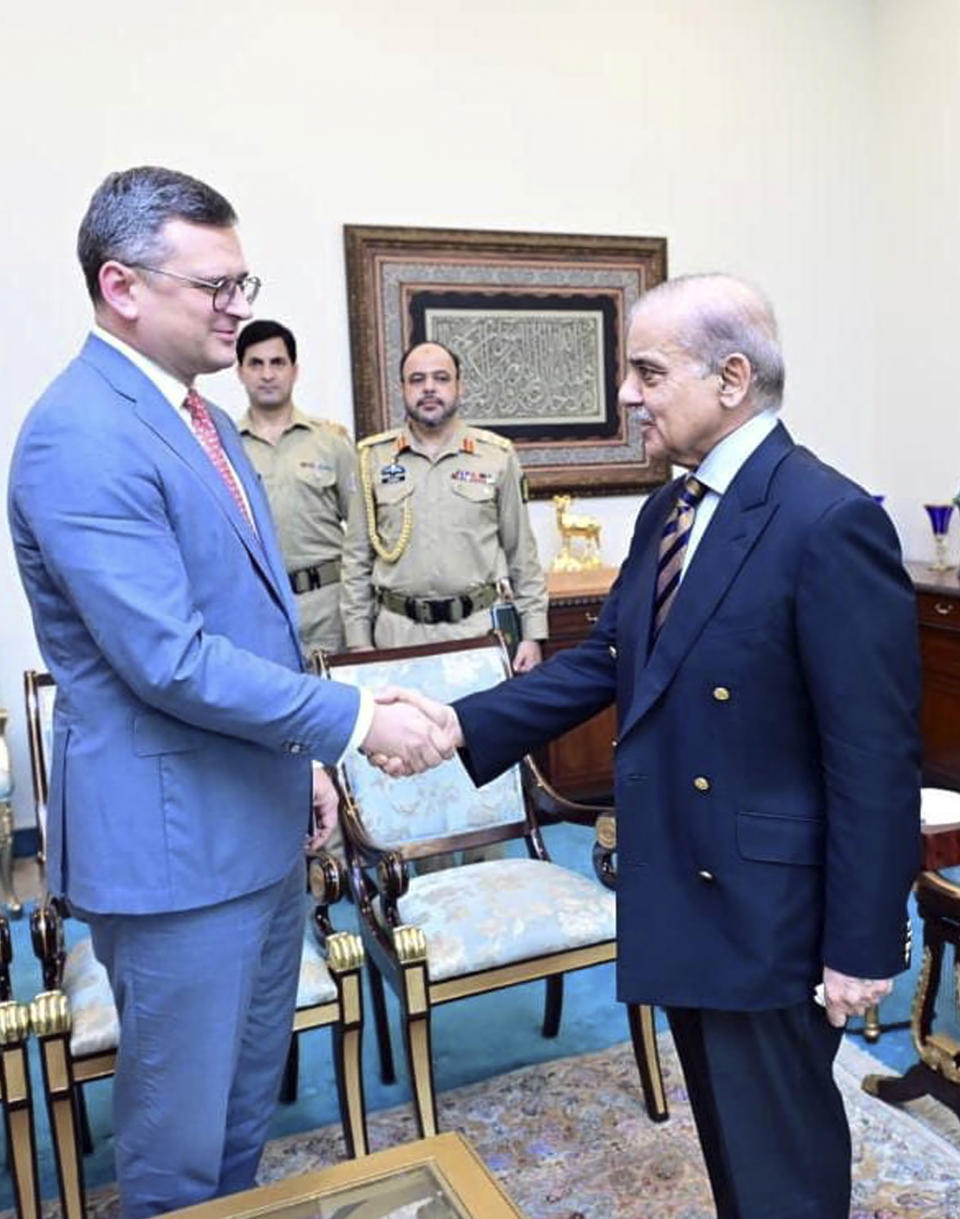 CORRECTS DAY TO THURSDAY, In this photo released by Pakistan Prime Minister Office, Prime Minister Shahbaz Sharif, right, shakes hands with Ukraine's Foreign Minister Dmytro Kuleba, at the Prime Minister's House, in Islamabad, Pakistan, Thursday, July 20, 2023. (Pakistan Prime Minister Office via AP)