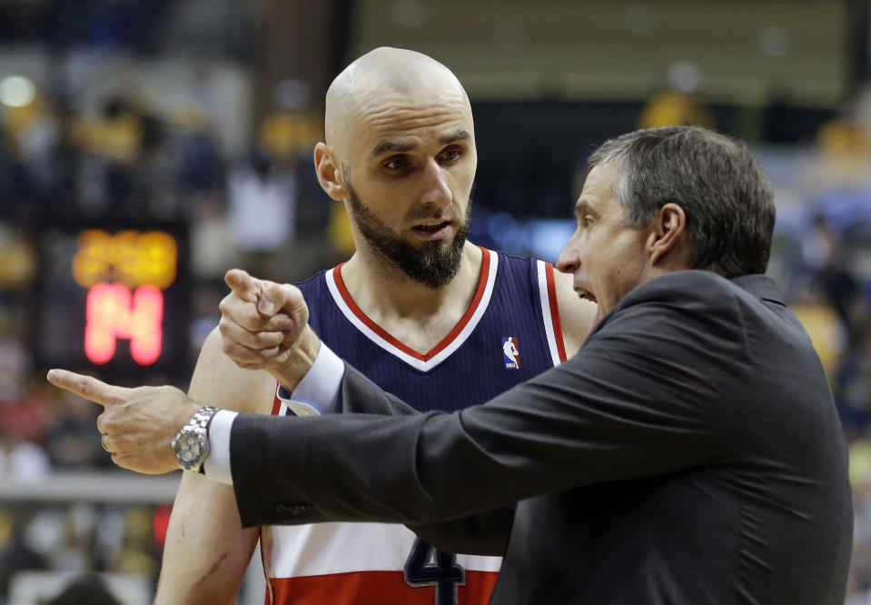 Washington Wizards head coach Randy Wittman talks with Marcin Gortat, left, during the first half of game 2 of the Eastern Conference semifinal NBA basketball playoff series against the Indiana Pacers, Wednesday, May 7, 2014, in Indianapolis. (AP Photo/Darron Cummings)