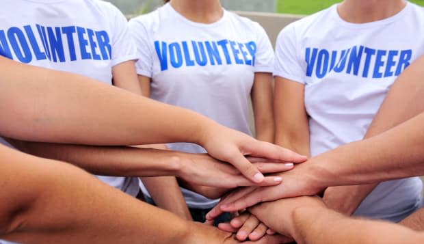 volunteer group hands together...