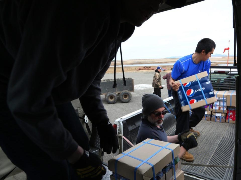 Supplies being unloaded from a plane that flew from Anchorage to the small village of Hooper Bay, Alaska.