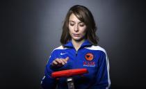 Olympic curler Jessica Schultz mimics how she prepares to sweep during the 2013 U.S. Olympic Team Media Summit in Park City, Utah October 2, 2013. REUTERS/Lucas Jackson (UNITED STATES - Tags: SPORT OLYMPICS PORTRAIT CURLING)