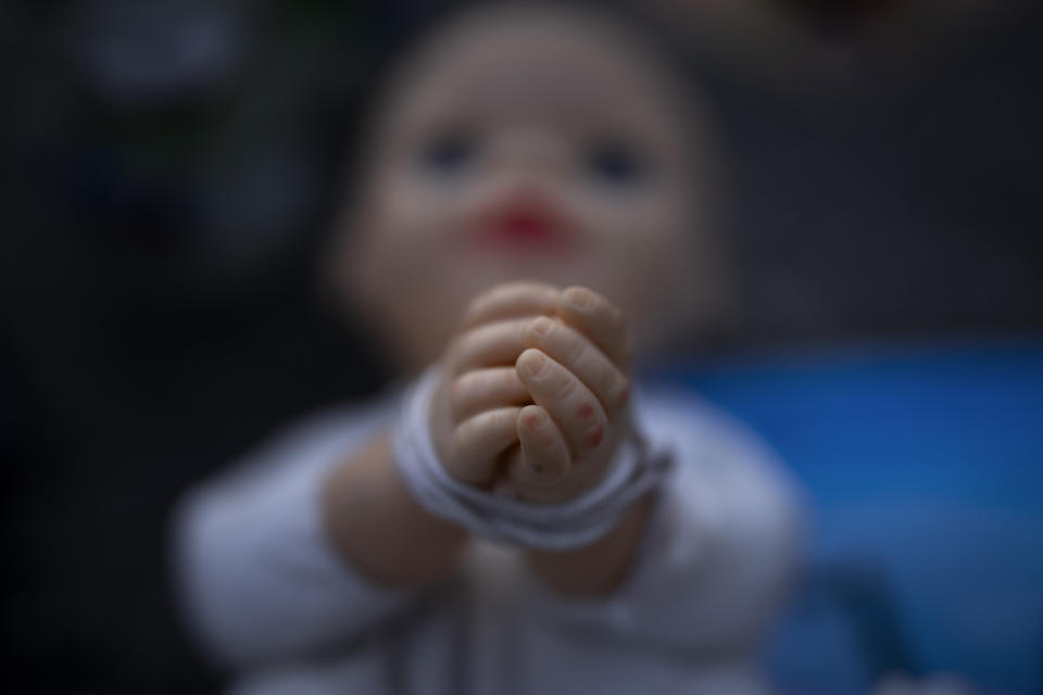 FILE - A baby doll symbolizing the small children who were abducted by Hamas militants during the group's Oct. 7 attack on Israel is displayed at a vigil for the victims in central Tel Aviv, Israel on Nov. 10, 2023. (AP Photo/Oded Balilty, File)