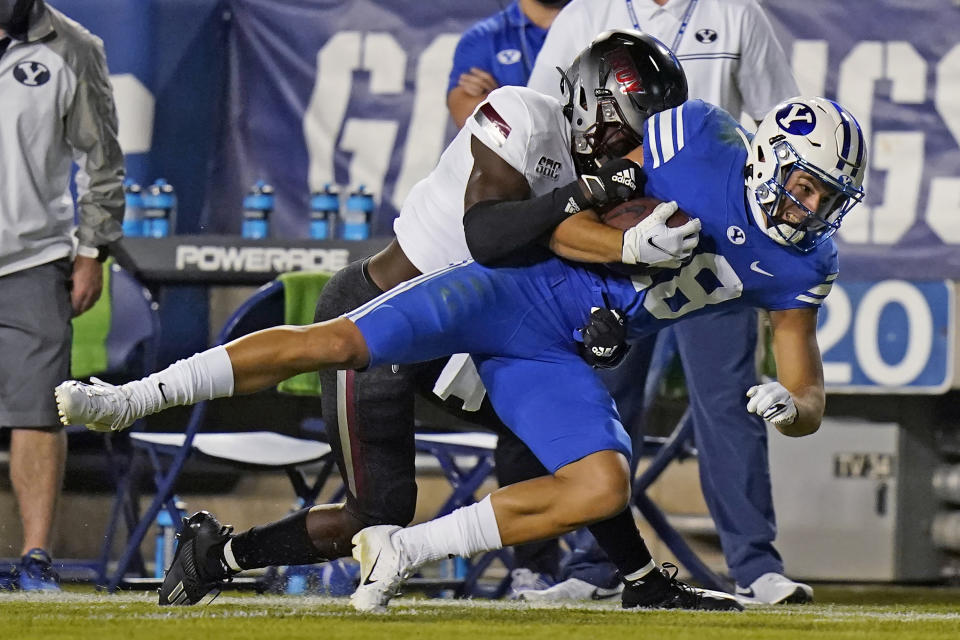 Troy safety Dell Pettus (31) tackles BYU wide receiver Gunner Romney during the first half during an NCAA college football game Saturday, Sept. 26, 2020, in Provo, Utah. (AP Photo/Rick Bowmer, Pool)