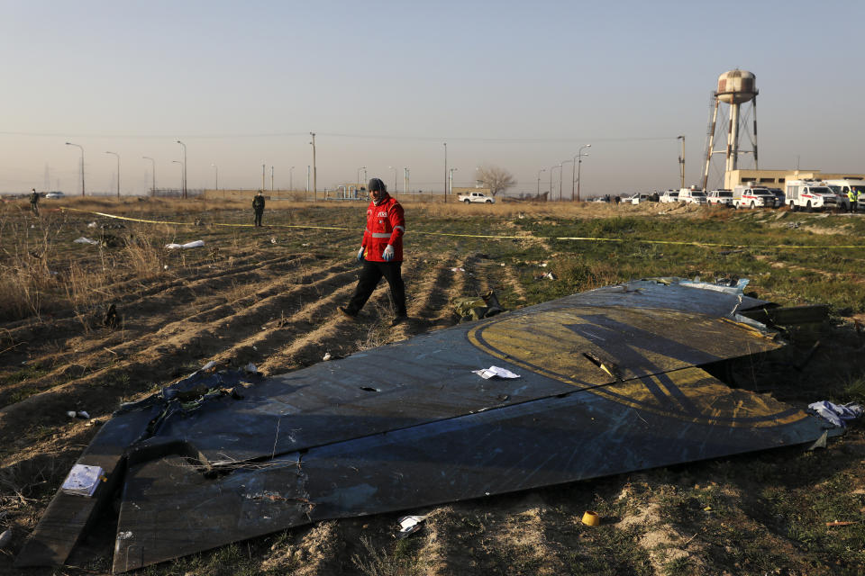 A rescue worker searches the scene where a Ukrainian plane crashed in Shahedshahr southwest of the capital Tehran, Iran, Wednesday, Jan. 8, 2020. (Photo: Ebrahim Noroozi/AP)