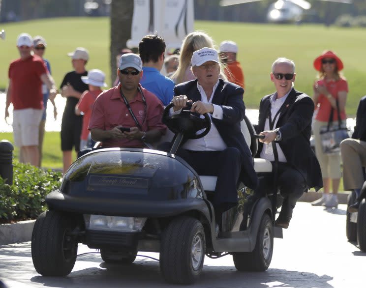 In this March 6, 2016, file photo, Donald Trump drives himself around a golf course to watch the final round of the Cadillac Championship golf tournament in Doral, Fla. (Photo: Luis Alvarez/AP)