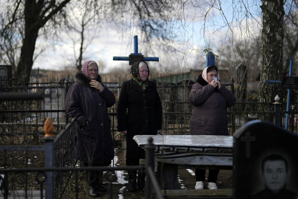 Mourners gather during the funeral of Vladyslav Bondarenko 26, in Kozyntsi, near Kyiv, Ukraine, Monday, March 6, 2023. Bondarenko, a paratrooper of airmobile brigade, died near Bakhmut on Feb 26. (AP Photo/Thibault Camus)