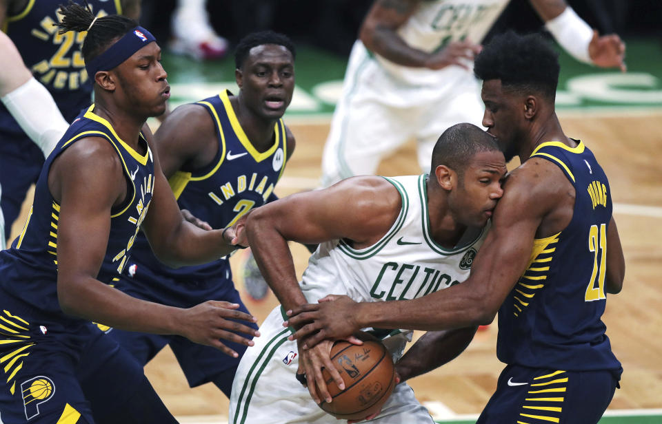Boston Celtics center Al Horford, is trapped by Indiana Pacers forward Thaddeus Young, right, during the first quarter of Game 2 of an NBA basketball first-round playoff series, Wednesday, April 17, 2019, in Boston. At left is Indiana Pacers center Myles Turner and Indiana Pacers guard Darren Collison (2)(AP Photo/Charles Krupa)