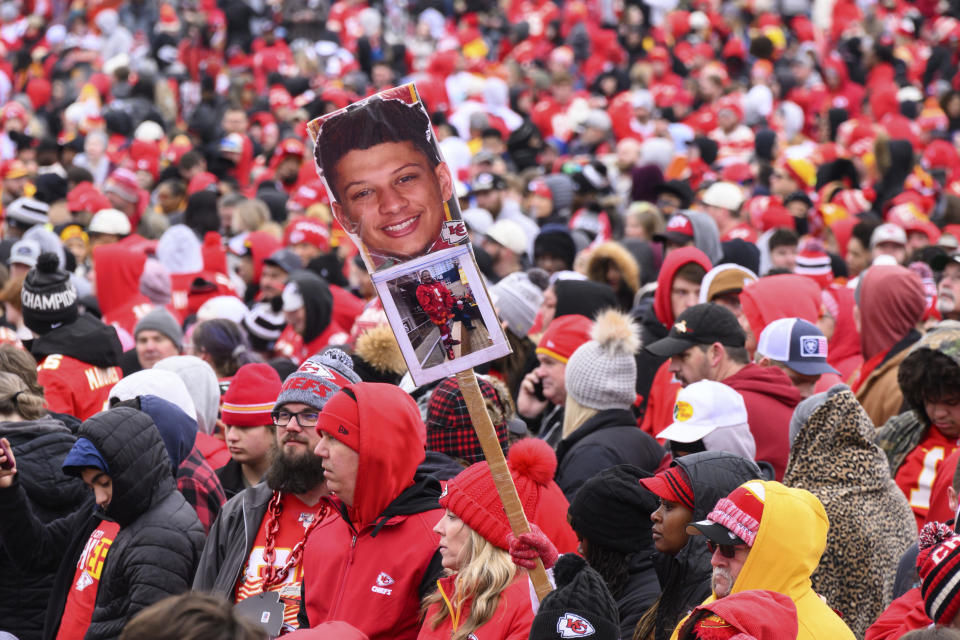 A fan waves a sign with Patrick Mahomes' photo on it during the Kansas City Chiefs' victory celebration and parade in Kansas City, Mo., Wednesday, Feb. 15, 2023. The Chiefs defeated the Philadelphia Eagles Sunday in the NFL Super Bowl 57 football game. (AP Photo/Reed Hoffman)