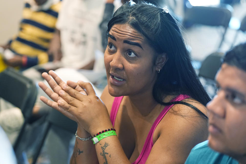 Dallenis Martinez talks about her journey to American while waiting to attend an orientation session for recent immigrants Monday, May 20, 2024, in Denver. (AP Photo/David Zalubowski)