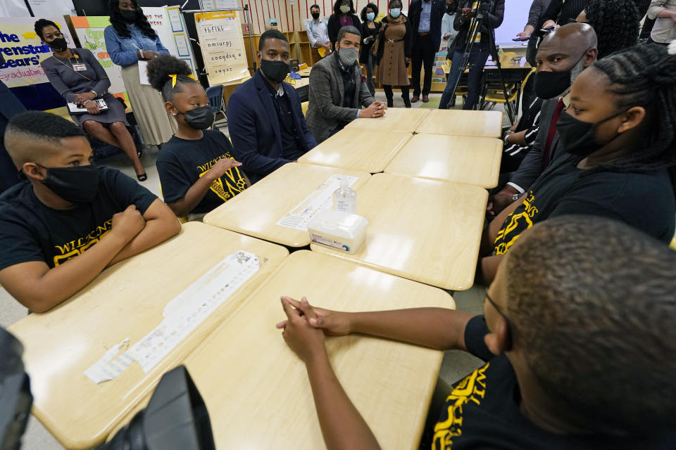 EPA Administrator Michael Regan, left center, and Jackson Mayor Chokwe Antra Lumumba, right, listen as fourth grader Kingston Lewis talks about a lack of water at his school, Wilkins Elementary School, Monday, Nov. 15, 2021, in Jackson, Miss. On Tuesday, Nov. 16, several schools resorted to virtual learning as the city reported low or no water pressure throughout the city and schools affected were closed for the day. Regan and others toured the school, as part of the agency's "Journey to Justice" tour through Mississippi, Louisiana and Texas, spotlighting longstanding environmental concerns in historically marginalized communities. (AP Photo/Rogelio V. Solis)