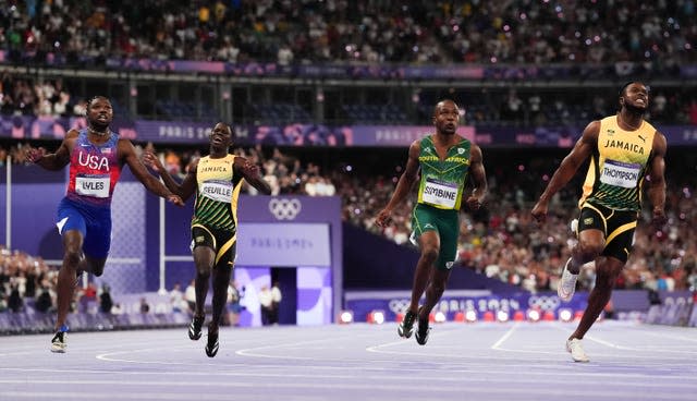 Noah Lyles and other sprinters crossing the finish line