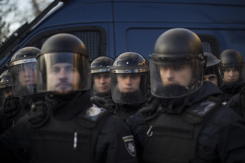 Ukrainian anti riot police cordon off the access to an election campaign rally of Petro Poroshenko, President of Ukraine and candidate for 2019 elections, during a demonstration by right-wing National Corps in Lviv, Ukraine, Thursday, March 28, 2019. Presidential elections will be held in Ukraine on 31 March 2019. (AP Photo/Emilio Morenatti)