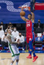 Philadelphia 76ers' Ben Simmons, right, dunks the ball with Boston Celtics' Daniel Theis, left, watching on during the first half of an NBA basketball game, Friday, Jan. 22, 2021, in Philadelphia. (AP Photo/Chris Szagola)