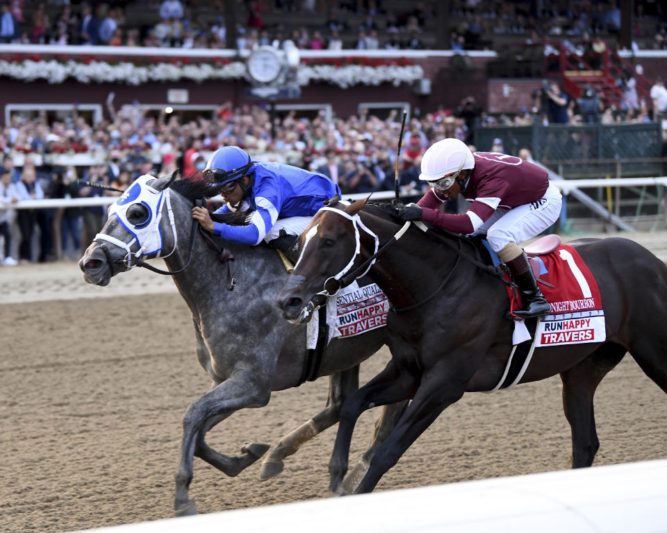 In a photo provided by the New York Racing Association, Essential Quality, left, with jockey Luis Saez, holds off Midnight Bourbon, with Ricardo Santana Jr., to win the Travers Stakes horse race Saturday, Aug. 28, 2021, at Saratoga Race Course in Saratoga Springs, N.Y. (Chelsea Durand/New York Racing Association via AP)