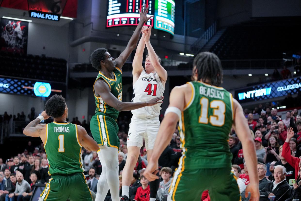 Cincinnati Bearcats guard Simas Lukosius (41) follows through on a game-winning 3-point basket in overtime of a college basketball game against the San Francisco Dons in the National Invitation Tournament, Wednesday, March 20, 2024, at Fifth Third Arena in Cincinnati.