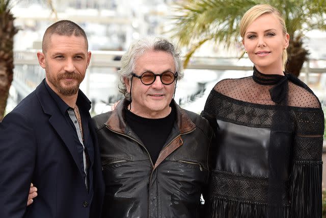 <p>George Pimentel/WireImage</p> Tom Hardy, George Miller and Charlize Theron on May 14, 2015