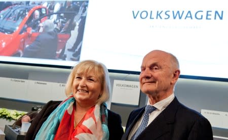 FILE PHOTO: Piech, chairman of board of German carmaker Volkswagen, and wife Ursula pose in front of company logo before annual shareholders meeting in Hamburg
