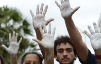 HANDS UP: Demonstrators attend an anti-government protest in Fortaleza, Brazil, on Friday. Picture: REUTERS