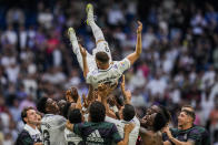 Real Madrid's Karim Benzema is thrown in the air by teammates after their Spanish La Liga soccer match against Athletic Bilbao at the Santiago Bernabeu stadium in Madrid, Sunday, June 4, 2023. (AP Photo/Bernat Armangue)