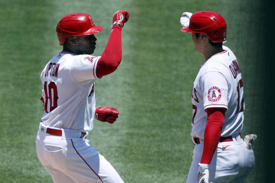 Los Angeles Angels Justin Upton, left, gets congratulations from designated hitter Shohei Ohtani, right, after hitting a solo home run against the Seattle Mariners during the first inning of a baseball game in Anaheim, Calif., Sunday, June 6, 2021. (AP Photo/Alex Gallardo)