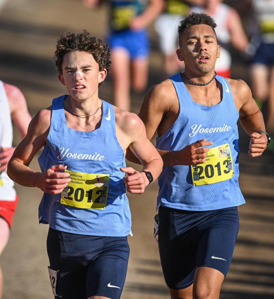 Yosemite High cross country runners Anthony Ruiz, left, and Ford Stegge run together near the leaders during the boys Division V state cross country championships at Woodward Park in Fresno on Saturday, Nov. 25, 2023.