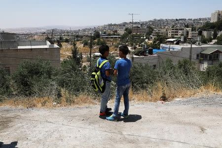 Palestinian school children chat outside a school in the East Jerusalem neighbourhood of Jabel Mukhaber June 12, 2017. REUTERS/Ammar Awad