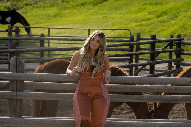 Lainey Wilson as Abby in the Season 5 premiere of "Yellowstone." Abby drinks whiskey; Wilson did not. "It was so early. I was like, 'I probably don't need a shot of whiskey right now.' The drink was colored water," says Wilson.