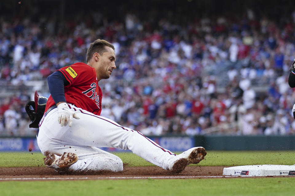 Atlanta Braves' Matt Olson slides into thrid base with a triple during the fourth inning of the team's baseball game against the Miami Marlins on Friday, June 30, 2023, in Atlanta. (AP Photo/John Bazemore)
