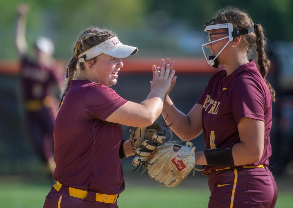 East Peoria's Gracie Luna, left, congratulates pitcher Meadow Terry on a strikeout against Washington on Tuesday, May 9, 2023 at Jan Smith Field in Washington. The Panthers defeated the Raiders 2-1.