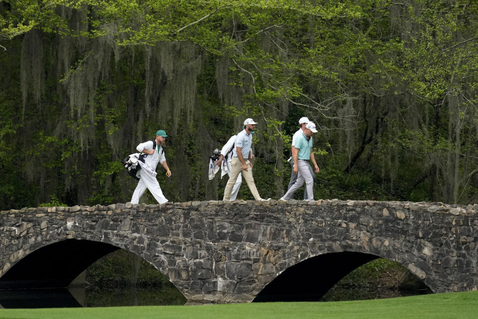 Justin Thomas, Max Homa and Gordon Sargent walks across the bridge on the 13th hole during a practice for the Masters golf tournament at Augusta National Golf Club, Monday, April 3, 2023, in Augusta, Ga. (AP Photo/Mark Baker)