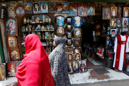 Women walk past a Christian souvenir shop ahead of Pope Francis’ visit in Cairo, Egypt April 27, 2017. REUTERS/Amr Abdallah Dalsh