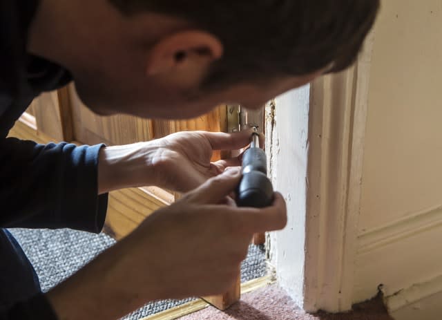 a man hanging a door