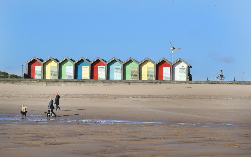 Dog walkers maintain social distancing at Blyth beach near Whitley Bay in Northern England as the UK continues in lockdown to help curb the spread of the coronavirus.