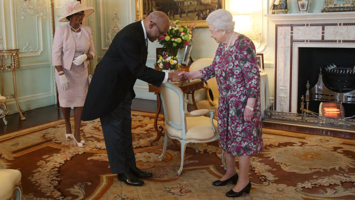 His Excellency Seth George Ramocan, the High Commissioner for Jamaica, presents his Letters of Commissioner, accompanied by his wife Dr Lola Ramocan, during a private audience with Queen Elizabeth II at Buckingham Palace, London.
