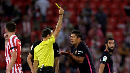 Football Soccer - Spanish Liga Santander - Athletic Bilbao v Barcelona - San Mames, Bilbao, Spain 28/08/16. Barcelona's Luis Suarez receives a yellow card during match. REUTERS/Vincent West