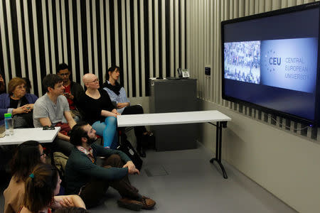 Students and faculty of the Hungary-based Central European University listen to the school's rector, Michael Ignatieff, address a town hall meeting after the government of Prime Minister Viktor Orban tabled a new bill that could force the 25-year-old school out of Hungary, in Budapest, Hungary March 29, 2017. REUTERS/Bernadett Szabo