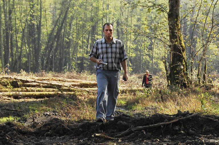 Suren Gazaryan walks in forest near the Sochi 2014 Winter Olympics site. Gazaryan is living in Estonia and says if he goes back to Russia he will be jailed by the officials whose illegal palaces he worked to expose