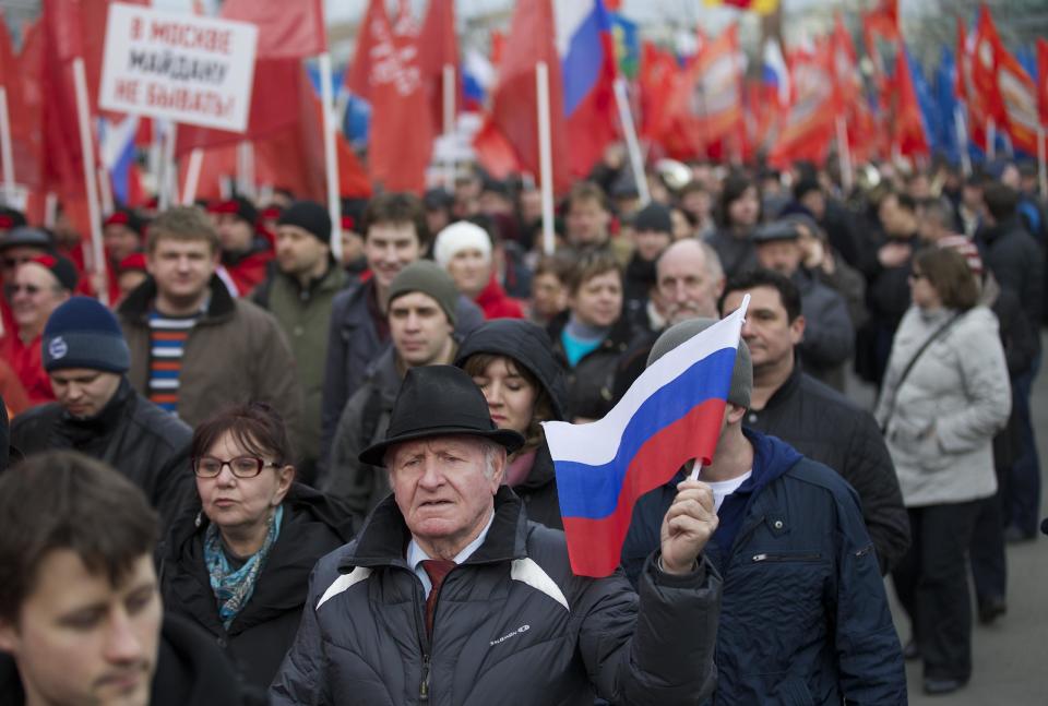 Demonstrators march in support of Kremlin-backed plans for the Ukrainian province of Crimea to break away and merge with Russia, in Moscow, Saturday, March 15, 2014. Large rival marches have taken place in Moscow over Kremlin-backed plans for Ukraine’s province of Crimea to break away and merge with Russia. The marchers belong to a group calling itself the “Essence of Time,” which professes to campaign for the interests of social progress in Russia and protect the interests of Russians. (AP Photo/Alexander Zemlianichenko)