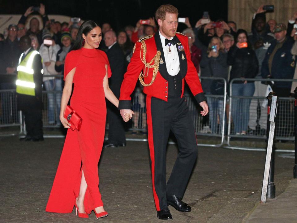 Harry and Meghan arrive at the Mountbatten Festival of Music in matching outfits PA