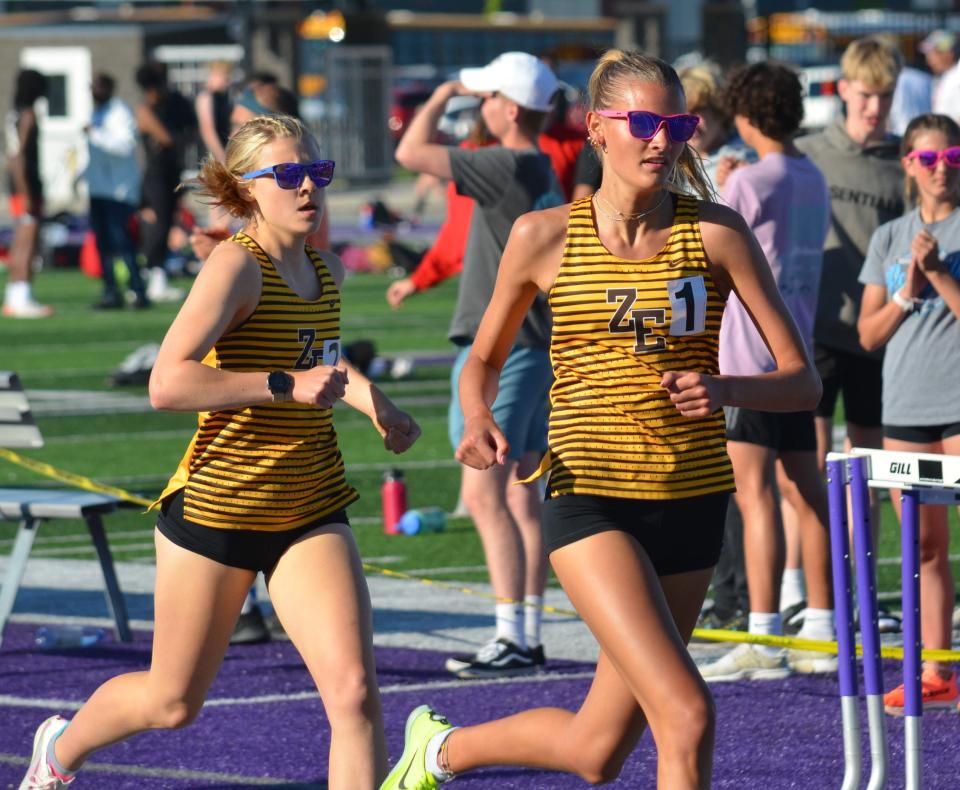 Zeeland East's Emma Drnek, right, and Allison Kuzma run the 1,600 meters at the OK Green Conference meet on Friday at Wyoming.