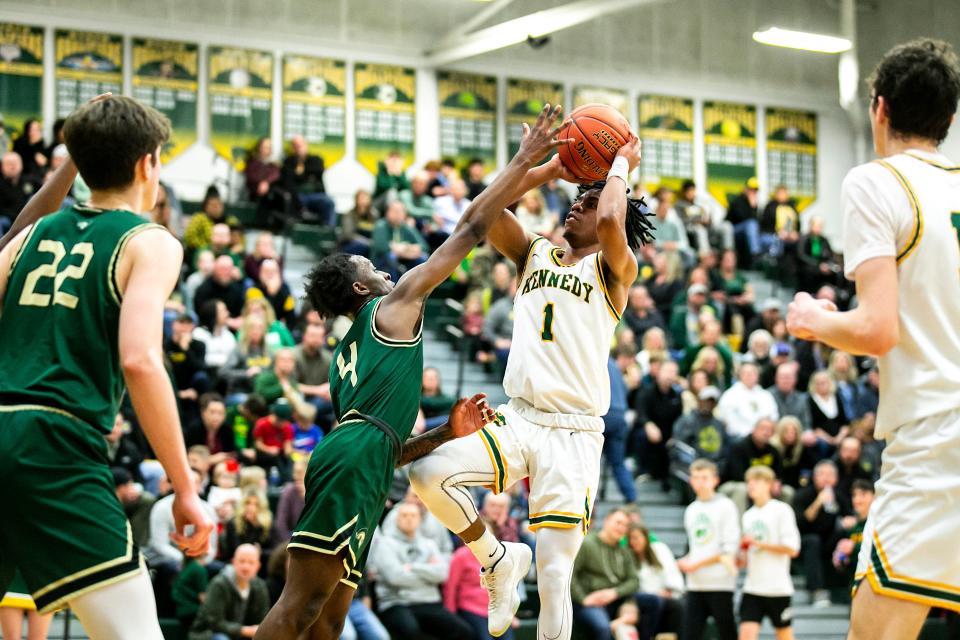 Cedar Rapids Kennedy's Kenzie Reed (1) shoots a basket as Iowa City West's TaeVeon Stevens (4) defends during a Class 4A high school boys basketball game on Tuesday.