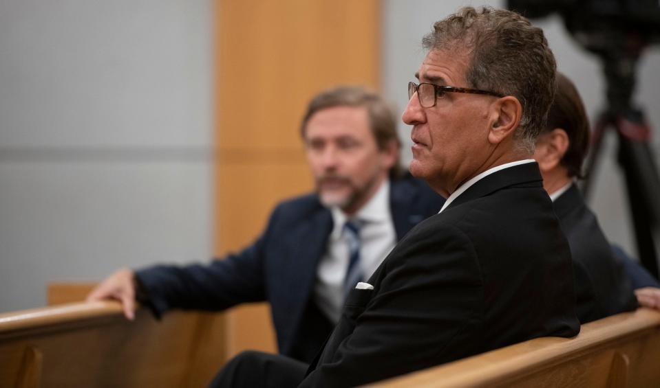 Pensacola dentist Charles Stamitoles waits in the courtroom with his legal team as they prepare for the jury selection process to begin Monday.