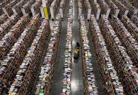 FILE PHOTO: Worker gathers items for delivery at Amazon's distribution center in Phoenix